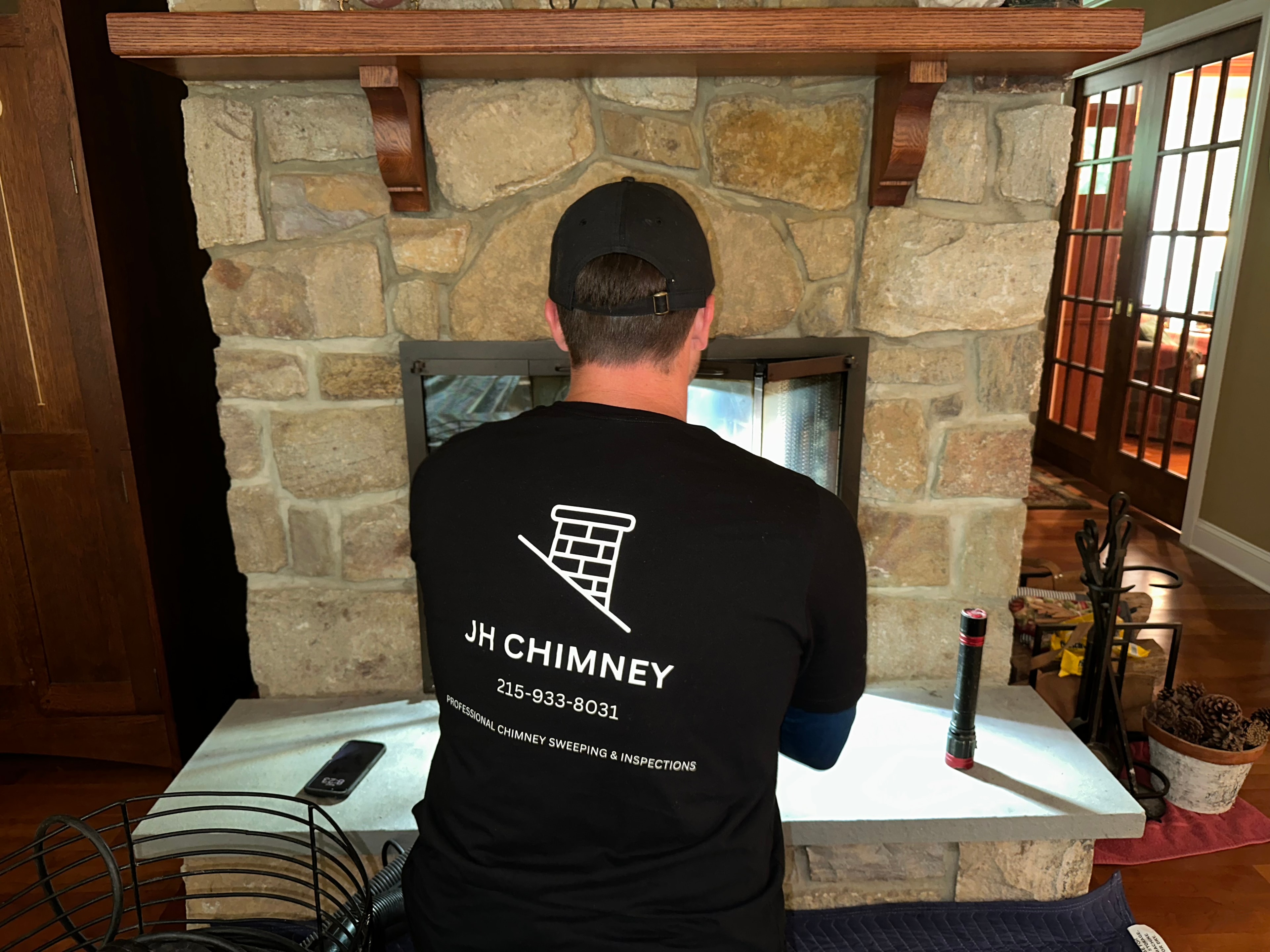 JH Chimney technician inspecting a fireplace